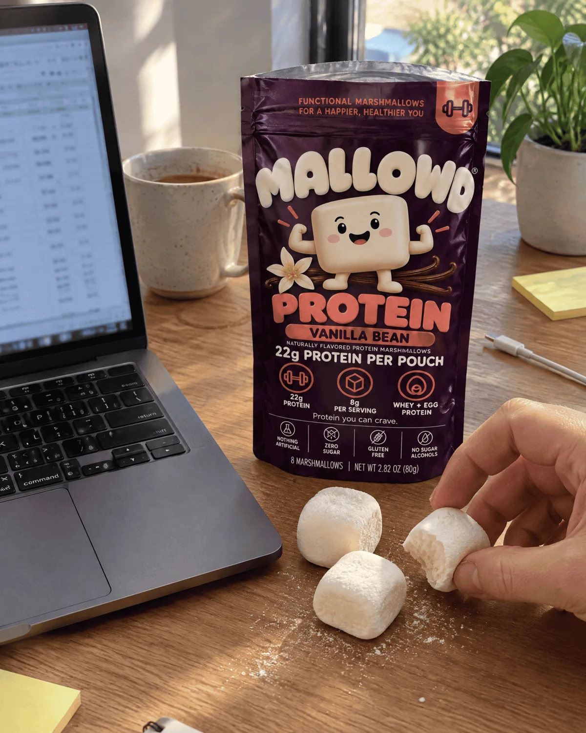 Hands passing a MALLOWD pouch across a table